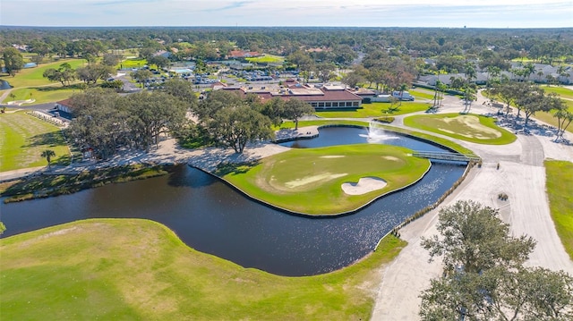 birds eye view of property with a water view and view of golf course