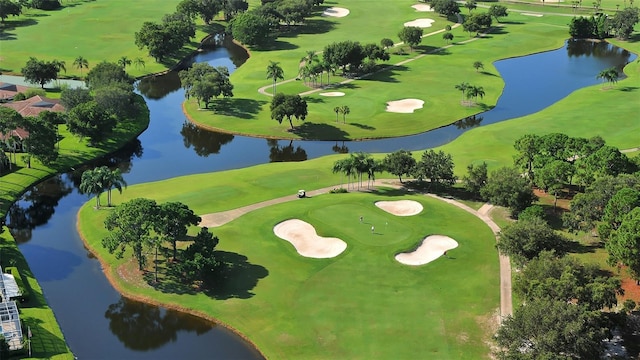 birds eye view of property with a water view and view of golf course