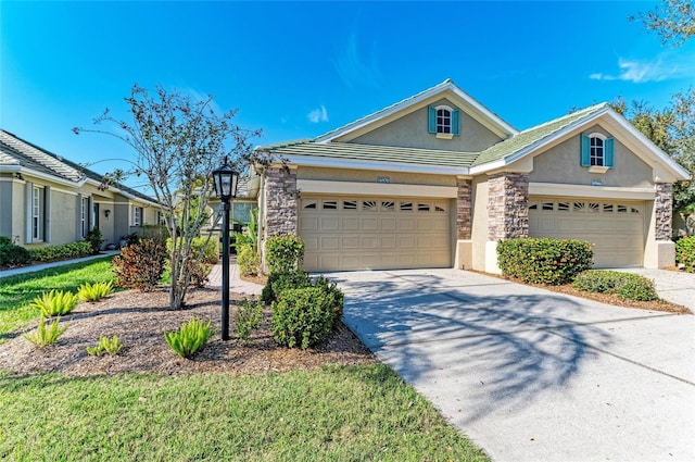 single story home with driveway, stone siding, an attached garage, and stucco siding