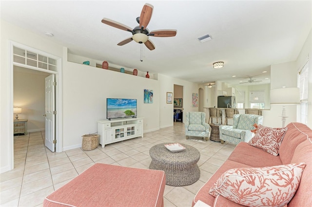 living room with a ceiling fan, visible vents, baseboards, and light tile patterned floors