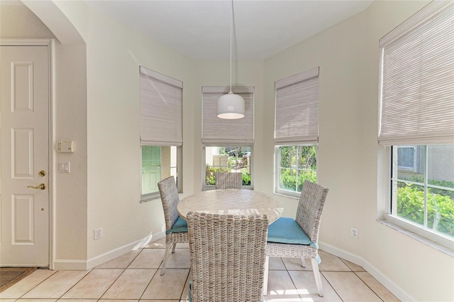 dining area featuring light tile patterned floors and baseboards