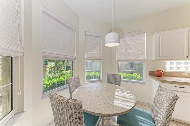 dining room with light tile patterned flooring and baseboards