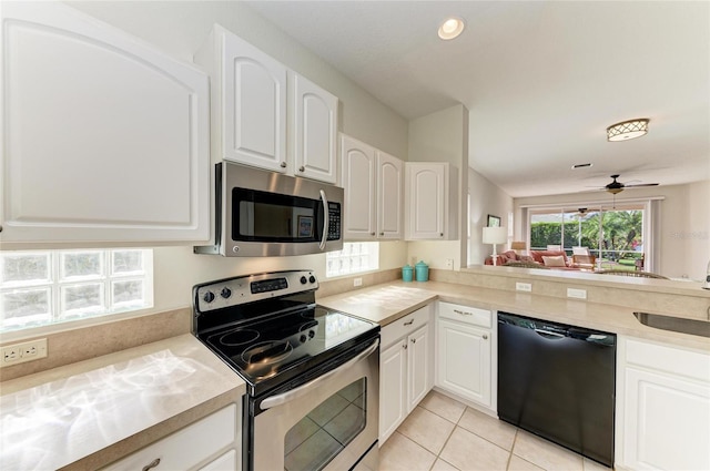 kitchen featuring stainless steel appliances, light countertops, a ceiling fan, white cabinets, and light tile patterned flooring