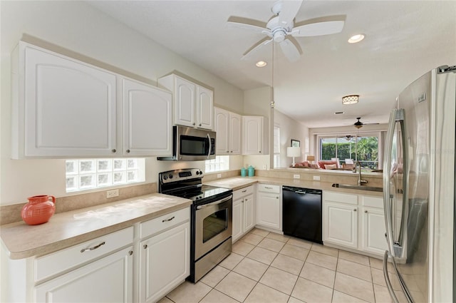 kitchen with ceiling fan, recessed lighting, stainless steel appliances, a sink, and light countertops