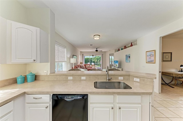 kitchen featuring light tile patterned floors, light countertops, white cabinetry, a sink, and dishwasher