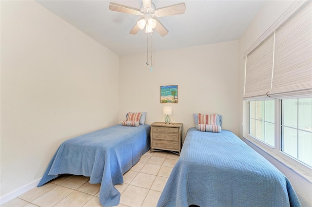 bedroom featuring baseboards, a ceiling fan, and tile patterned floors