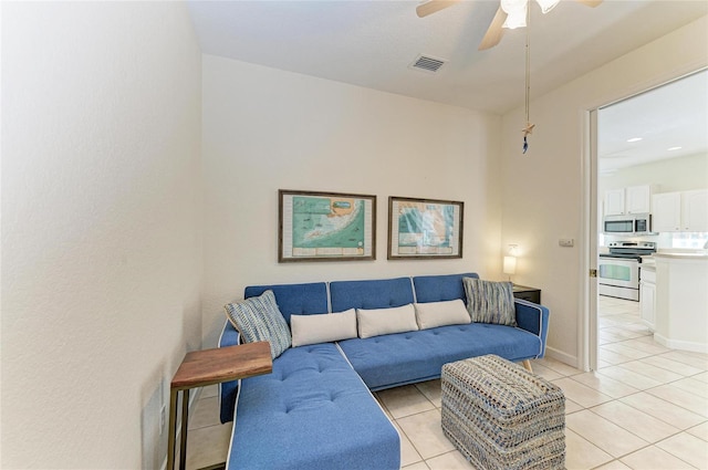 living area featuring baseboards, visible vents, a ceiling fan, and light tile patterned flooring