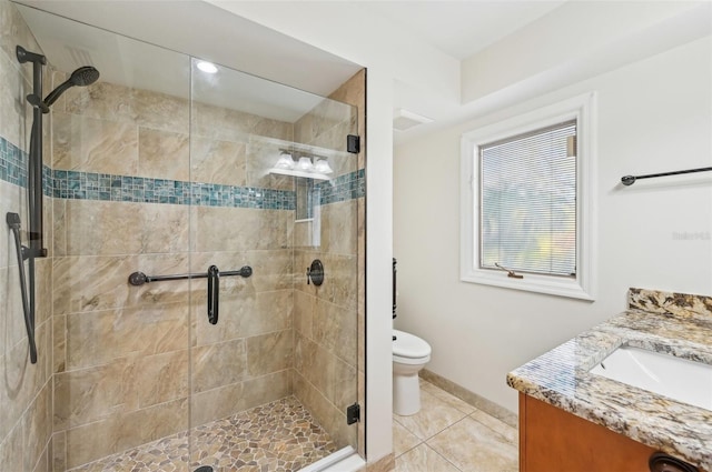 bathroom with baseboards, toilet, tile patterned floors, vanity, and a shower stall