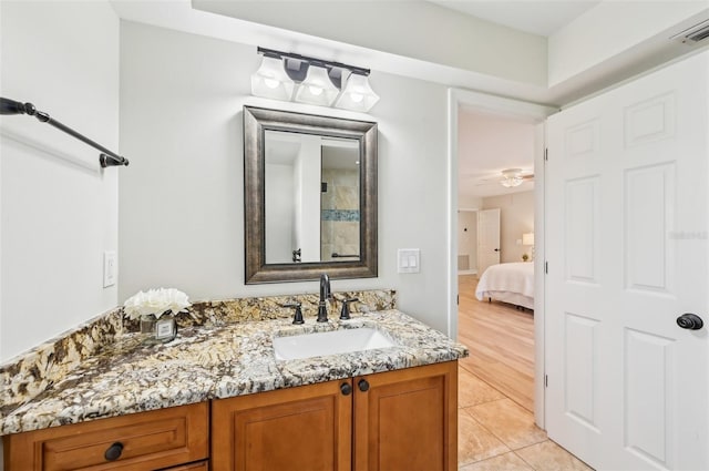 bathroom with tile patterned flooring, visible vents, vanity, and ensuite bathroom