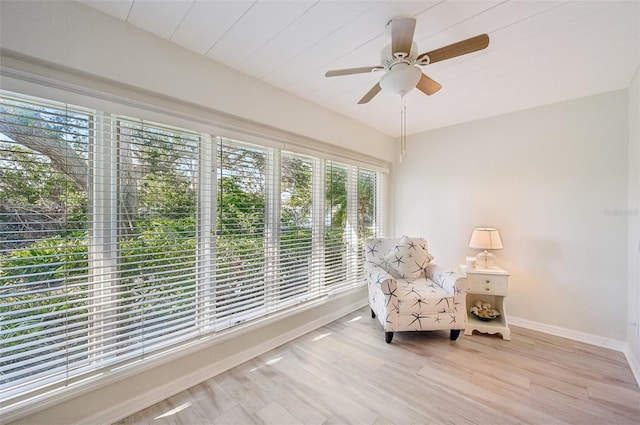 living area with ceiling fan, baseboards, and wood finished floors