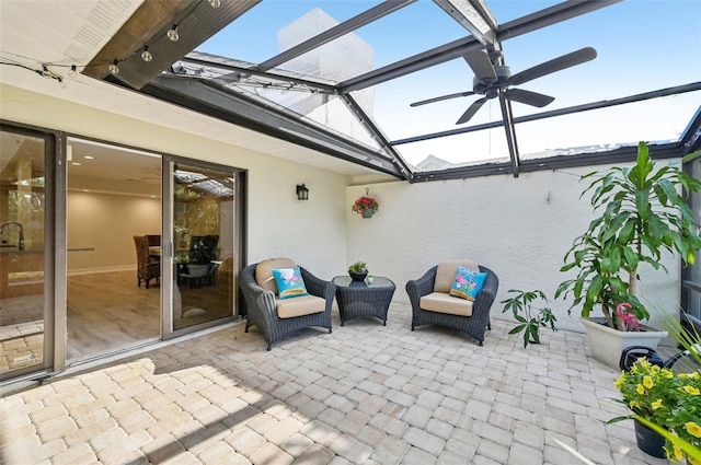 view of patio with a lanai and a ceiling fan