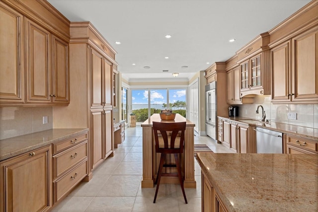1364 Point Crisp Rd, Sarasota, FL 34242 - kitchen featuring glass insert cabinets, a sink, appliances with stainless steel finishes, backsplash, and light stone counters