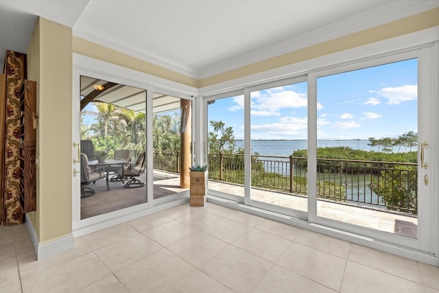 1364 Point Crisp Rd, Sarasota, FL 34242 - interior space with a water view, light tile patterned floors, and crown molding