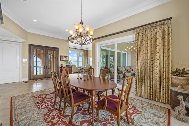 1364 Point Crisp Rd, Sarasota, FL 34242 - dining space featuring crown molding, french doors, an inviting chandelier, and tile patterned flooring