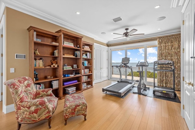 1364 Point Crisp Rd, Sarasota, FL 34242 - workout area featuring crown molding, visible vents, ceiling fan, and wood finished floors
