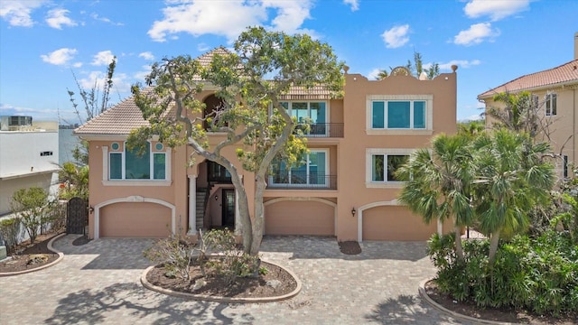 1364 Point Crisp Rd, Sarasota, FL 34242 - view of front of house featuring a garage, stucco siding, and decorative driveway