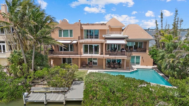 1364 Point Crisp Rd, Sarasota, FL 34242 - back of property featuring a patio area, a balcony, stucco siding, and an outdoor pool