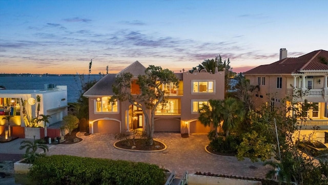 1364 Point Crisp Rd, Sarasota, FL 34242 - view of front of property featuring curved driveway, a garage, and stucco siding