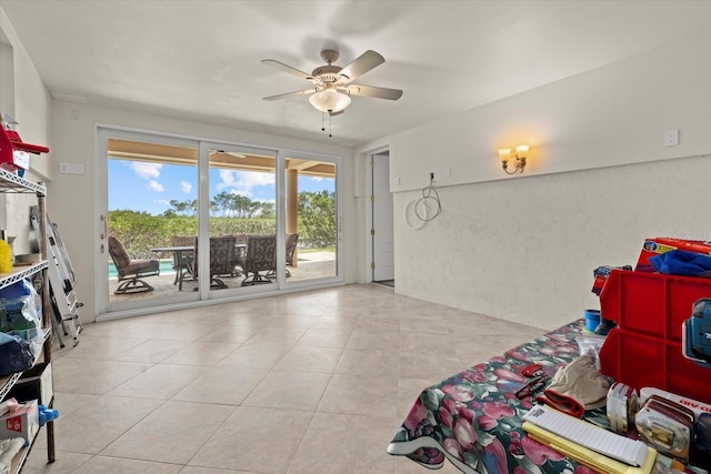 1364 Point Crisp Rd, Sarasota, FL 34242 - bedroom with access to exterior, a ceiling fan, tile patterned flooring, and a textured wall