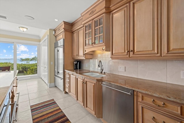 1364 Point Crisp Rd, Sarasota, FL 34242 - kitchen with stone countertops, tasteful backsplash, light tile patterned flooring, appliances with stainless steel finishes, and a sink
