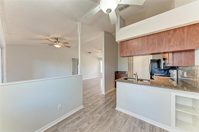 kitchen featuring a sink, visible vents, a ceiling fan, stainless steel electric range oven, and brown cabinetry