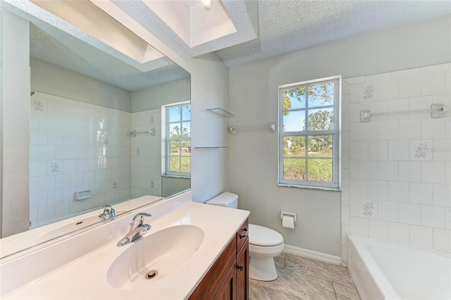 full bathroom featuring bathtub / shower combination, toilet, a textured ceiling, vanity, and baseboards