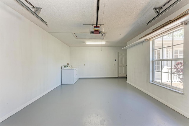 garage with baseboards, washer and clothes dryer, and a garage door opener