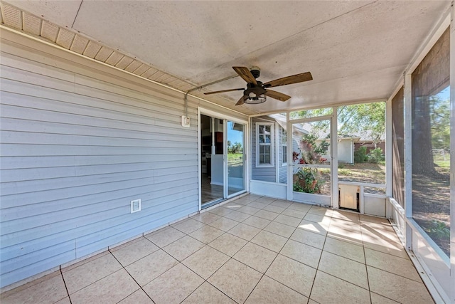 unfurnished sunroom featuring ceiling fan