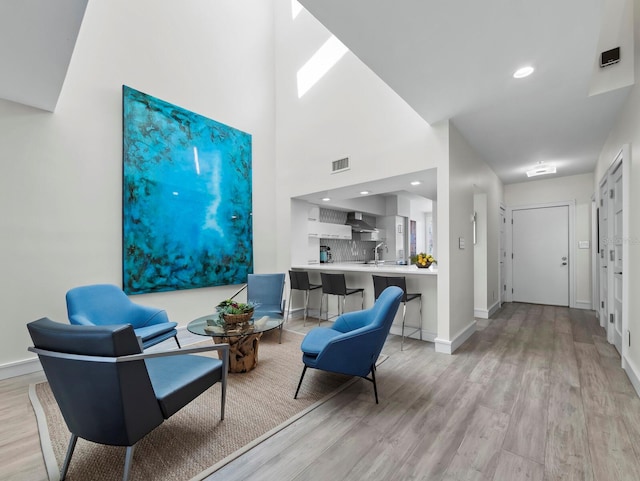 sitting room featuring recessed lighting, visible vents, baseboards, and light wood-style floors