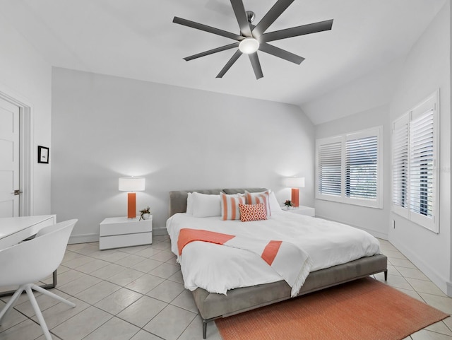 bedroom featuring light tile patterned floors, baseboards, a ceiling fan, and vaulted ceiling