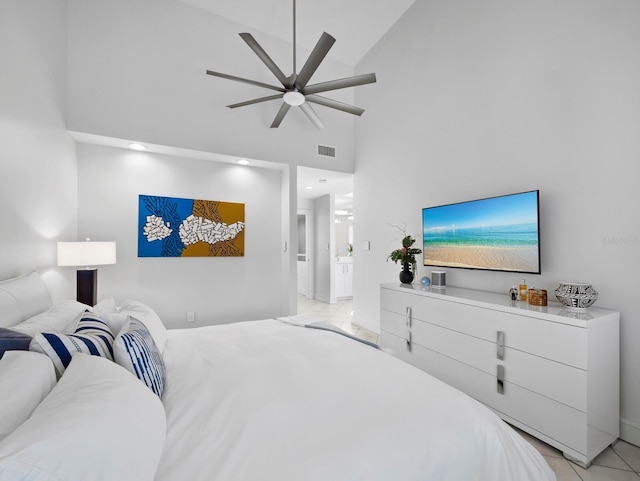 bedroom featuring light tile patterned floors, visible vents, a towering ceiling, and ceiling fan