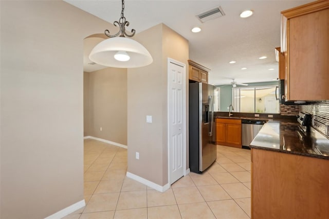 kitchen with stainless steel appliances, light tile patterned flooring, visible vents, and decorative backsplash