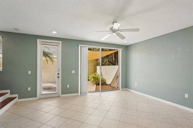 empty room featuring plenty of natural light, baseboards, and stairs