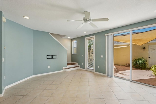 empty room with light tile patterned floors, ceiling fan, baseboards, and recessed lighting