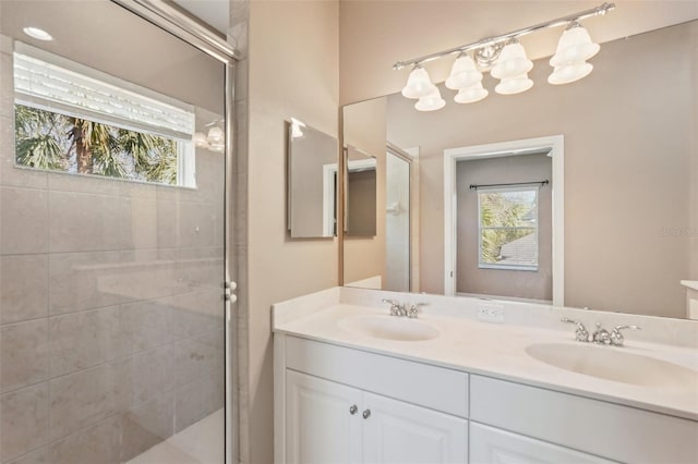 full bath with a wealth of natural light, a sink, and a stall shower