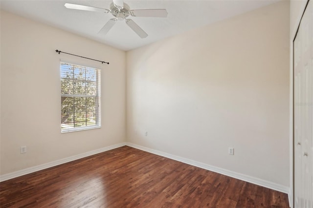 spare room with ceiling fan, baseboards, and wood finished floors