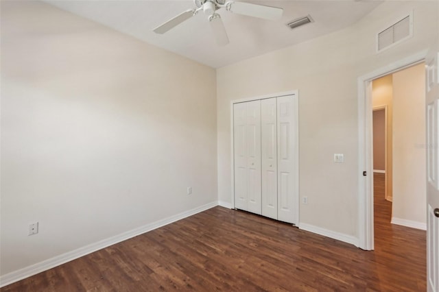 unfurnished bedroom with baseboards, visible vents, and dark wood-style flooring