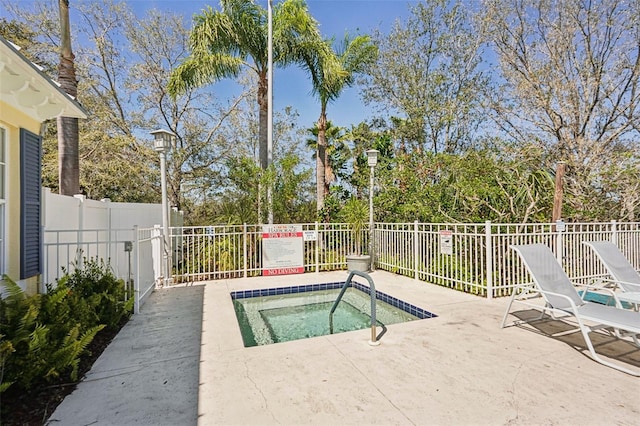 view of swimming pool with a patio area and fence