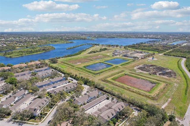 drone / aerial view with a water view and a residential view