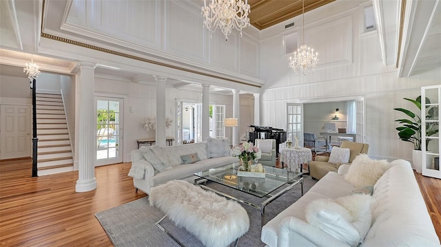 7715 Westmoreland Dr, Sarasota, FL 34243 - living area with light wood-style flooring, stairs, and ornate columns