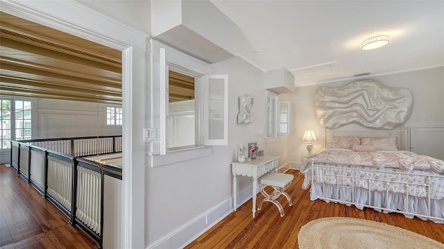 7715 Westmoreland Dr, Sarasota, FL 34243 - bedroom featuring baseboards, multiple windows, and hardwood / wood-style flooring