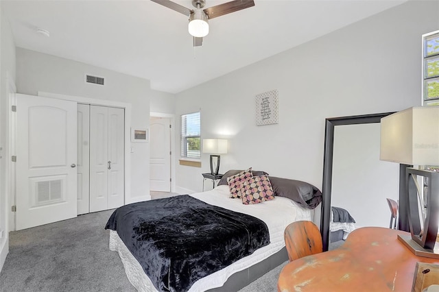 carpeted bedroom featuring a closet, visible vents, and a ceiling fan