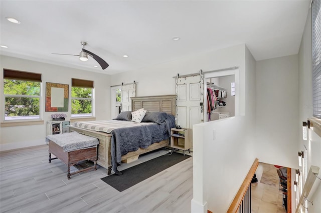 bedroom featuring recessed lighting, light wood-style floors, a ceiling fan, and baseboards