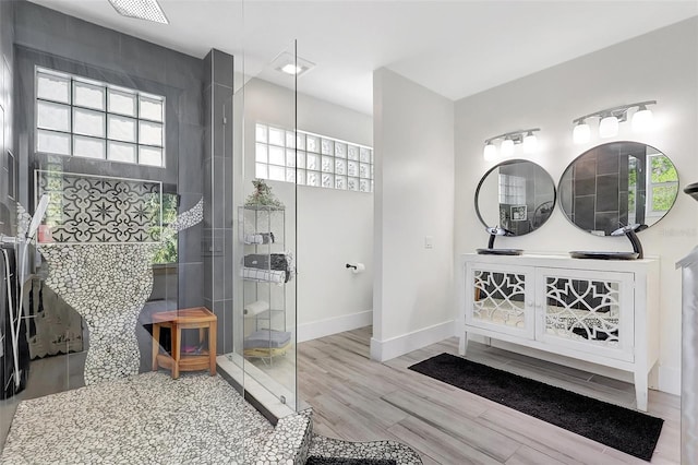 full bathroom with baseboards, walk in shower, and wood finished floors