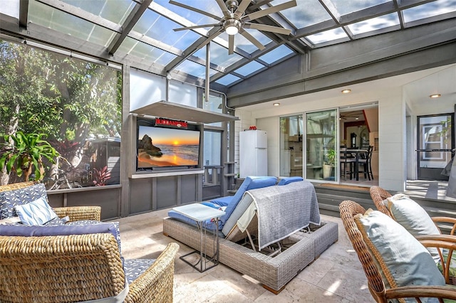 sunroom with an outdoor living space, a skylight, and ceiling fan