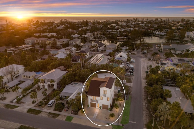 aerial view at dusk featuring a residential view