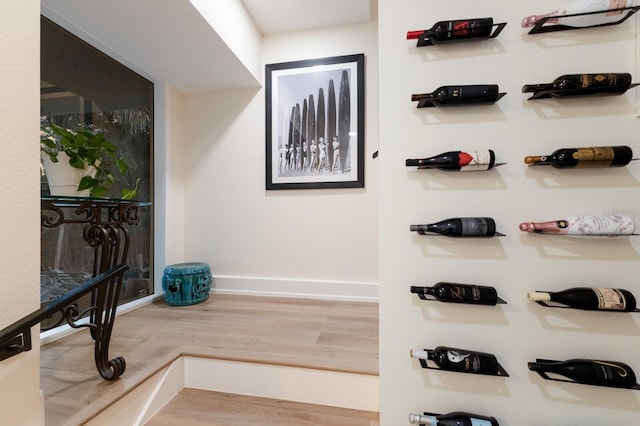 wine room featuring wood finished floors and baseboards