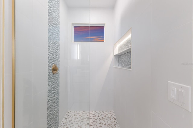 full bath featuring a tile shower