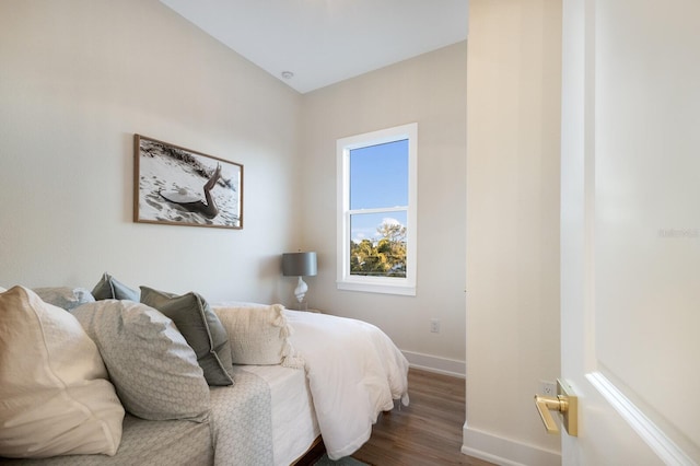 bedroom featuring baseboards and wood finished floors