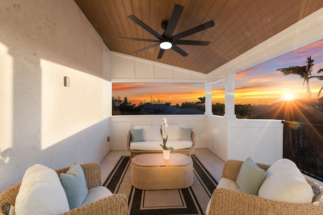 patio terrace at dusk with outdoor lounge area and ceiling fan